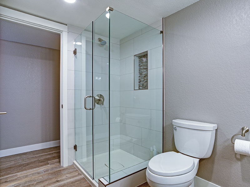Modern bathroom with a frameless glass shower in the corner.