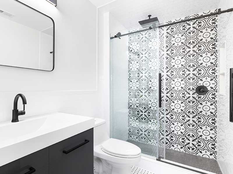Modern, small bathroom with a sliding glass shower door.